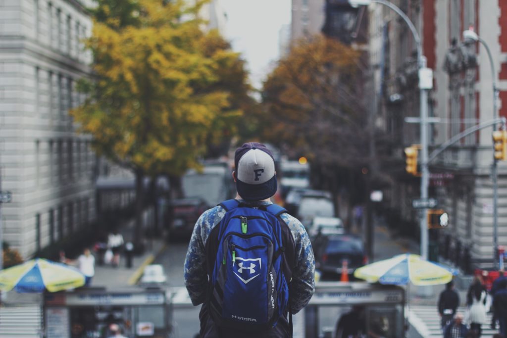 man with backpack in a city
